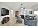 Comfortable living room with tile flooring, a large gray sectional, and entertainment center at 404 Willow Run, Lakeland, FL 33813