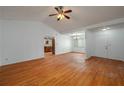 Spacious living room with wood floors, white walls, and a ceiling fan at 409 San Jose Dr, Winter Haven, FL 33884