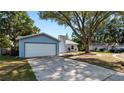 Charming single-story home with a well-maintained lawn and a two-car garage in a neighborhood setting at 417 Yolonda Ct, Lakeland, FL 33809