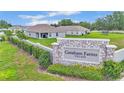 Entrance to Gresham Farms Village features stone signage and manicured landscaping at 4582 Penkert Pl, Lakeland, FL 33811