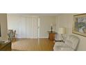 Bright living room with hardwood floors, featuring a large sliding door and neutral decor at 5211 Berkley Rd, Auburndale, FL 33823