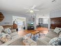 Cozy living room with comfortable seating, ceiling fan, and view of the kitchen and dining area at 6087 Southern Oaks Se Dr, Winter Haven, FL 33884