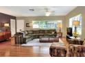 Spacious living room with hardwood floors, large windows, and a comfortable sectional sofa at 618 W Oak Dr, Lakeland, FL 33803