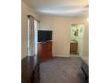Bedroom with a large window, TV, dresser, and ensuite bathroom at 629 N Cleveland Ave, Fort Meade, FL 33841