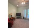 Inviting living room with carpet, ceiling fan and access to the outdoors at 629 N Cleveland Ave, Fort Meade, FL 33841