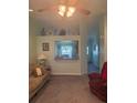 Comfortable living room with open view to the kitchen area and cozy furnishings at 629 N Cleveland Ave, Fort Meade, FL 33841