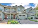 Charming two-story townhome features a one car garage and inviting front yard at 6435 Sedgeford Dr, Lakeland, FL 33811