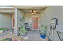 Cozy front porch with rocking chair, plants, and decorative door wreath at 6435 Sedgeford Dr, Lakeland, FL 33811