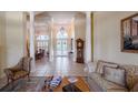 Spacious living room with tile floors, columns, and a view into the foyer and formal dining area at 645 Whisper Woods Dr, Lakeland, FL 33813