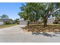 Charming single-story home with brick accents, a two-car garage, and a lush front yard at 790 Chelsea Way, Lake Wales, FL 33853