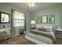 Charming bedroom with soothing green tones, decor, and a view to the outside at 9093 S Bay Dr, Haines City, FL 33844