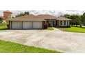 Charming home with a three-car garage, and a inviting walkway leading to the front door at 9093 S Bay Dr, Haines City, FL 33844