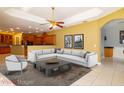 Spacious living room featuring an open floor plan, large sectional sofa, and access to the kitchen at 9093 S Bay Dr, Haines City, FL 33844