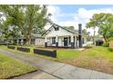 Exterior view of a well-maintained home with a cozy front porch and manicured lawn at 911 S Missouri Ave, Lakeland, FL 33803