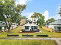 Charming bungalow with a cozy front porch, dark trim, and a meticulously landscaped front yard at 911 S Missouri Ave, Lakeland, FL 33803