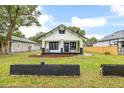 Inviting front exterior with a quaint porch, beautiful lawn, and well-maintained curb appeal at 911 S Missouri Ave, Lakeland, FL 33803