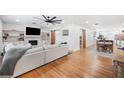 Open living room with hardwood floors, fireplace, and barn doors to adjacent rooms at 916 Woodward St, Lakeland, FL 33803