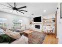 Comfortable living room features a stone fireplace, wood floors and modern decor at 916 Woodward St, Lakeland, FL 33803