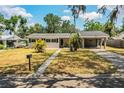 Quaint one-story home with covered parking and mature landscaping in a quiet neighborhood at 960 Lila St, Bartow, FL 33830