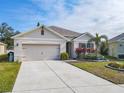 Inviting single-story home with well-manicured lawn and a wide driveway leading to the garage at 120 Grove Branch Rd, Winter Haven, FL 33880