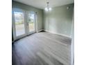 Bright dining room with new floors and elegant lighting at 1329 Tom Watson Rd, Lakeland, FL 33801