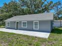 Gray single-story home featuring a new roof, green front door, and a freshly poured concrete sidewalk at 1415 Southern Ave, Lakeland, FL 33803