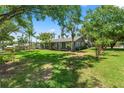 Landscaped side yard with mature trees, shrubbery, and grass at 1628 Lakewood S Dr, Lakeland, FL 33813