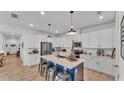 Bright kitchen featuring a center island with seating, modern appliances, and ample white cabinetry at 1725 Hill Top Dr, Dundee, FL 33838