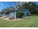 Charming one-story home featuring landscaped yard with decorative rock, mature plantings, and manicured lawn at 1920 Indian Trails Ct, Lakeland, FL 33813