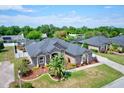 Birds-eye view of a single story house with a well manicured lawn and neutral exterior paint at 2032 Indian Sky Cir, Lakeland, FL 33813