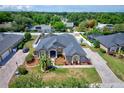 An aerial view of a lovely single-story home featuring a driveway and lush lawn at 2032 Indian Sky Cir, Lakeland, FL 33813