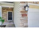 Close-up of the townhome's entrance and attached garage, showing the stone facade and exterior lighting at 2047 Winterset Dr, Lakeland, FL 33813