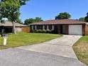 Cozy brick home features an attached garage and a long driveway at 2323 Ridgeview Dr, Lakeland, FL 33810