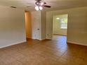Bright living room with neutral walls, ceiling fan, and tile flooring at 2323 Ridgeview Dr, Lakeland, FL 33810