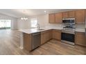 Spacious kitchen featuring stainless steel appliances, stylish cabinetry, and a center island with seating at 2331 Northumberland Ct, Haines City, FL 33844