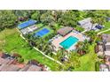 Stunning aerial view of community amenities including a pool, clubhouse, and tennis courts at 30 Aspen Dr # 30, Haines City, FL 33844