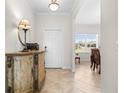 The Foyer has a vintage cabinet with tile flooring leading to a dining area at 3136 Langdon Ln, Winter Haven, FL 33884