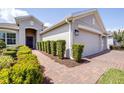Inviting walkway of a single Gathering home leads to a front entrance with manicured greenery at 3136 Langdon Ln, Winter Haven, FL 33884