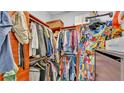 Walk-in closet with custom shelving and hanging racks provides ample storage space at 3243 Red Tail Hawk Dr, Polk City, FL 33868
