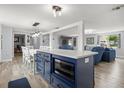Eat-in kitchen with a navy island and hardwood flooring in an open concept home at 3810 Harrelson Rd, Lakeland, FL 33810