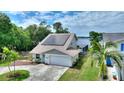 Beautiful home showcasing a two-car garage, solar panels, and waterfront views at 440 Lake Daisy, Winter Haven, FL 33884