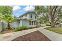 Charming light blue two-story home with mature trees and a long driveway at 516 Windsor St, Lakeland, FL 33803