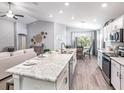 Spacious open-concept kitchen with a large island, modern appliances, seamlessly connected to the dining and living areas at 5424 Se 127Th Ln, Belleview, FL 34420