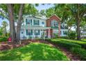 Beautiful two-story home with green shutters, surrounded by well-maintained landscaping and mature trees at 5425 Charlin Ave, Lakeland, FL 33810