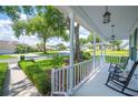 Inviting front porch featuring classic rocking chairs and decorative lighting, perfect for relaxing outdoors at 5425 Charlin Ave, Lakeland, FL 33810