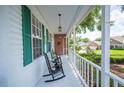 Cozy front porch with rocking chairs, decorative lighting, and charming details, offering a relaxing outdoor space at 5425 Charlin Ave, Lakeland, FL 33810