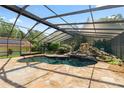 The screened-in pool area has a stone patio and a waterfall feature, perfect for relaxing and entertaining at 5425 Lewellyn Rd, Lakeland, FL 33810