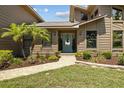 View of the home's entryway, showcasing the landscaping and front door at 5519 Club W Hl, Lakeland, FL 33812