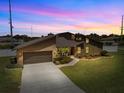 Striking shot of the property at sunset, highlighting the unique architectural design and landscaping at 5519 Club W Hl, Lakeland, FL 33812