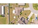 Aerial view of a private home and backyard including a circular pool and patio area at 555 Heather Glen Dr, Winter Haven, FL 33884